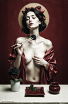 Mujer de pecho desnudo ante un fondo rojo, cubierta parcialmente con una tela escarlata y sosteniendo una rosa en una escena de sensualidad contenida.