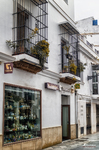 Fachada comercial en una calle de Rota, con balcón, escaparate y arquitectura tradicional.