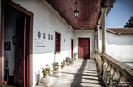 Galería porticada de una casa o edificio histórico en el norte de España, con barandilla y macetas.
