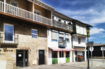 Fachadas tradicionales de Chaves con balcones acristalados y piedra, en el casco histórico portugués.