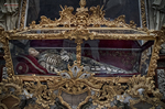 Relicario barroco dorado con fondo rojo en una iglesia de Kutná Hora.