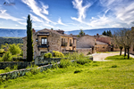 Casa rural de Pedraza con jardín verde y paisaje al fondo.