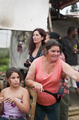 Mujeres y niñas observan una actividad cultural de Caravan en un entorno urbano.