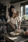 África corta pan y queso sobre una mesa de madera en la cocina rústica de una casa de Treceño.