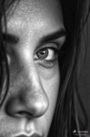 Primer plano de un ojo de Carmen, con parte de la nariz y el cabello en sombra.